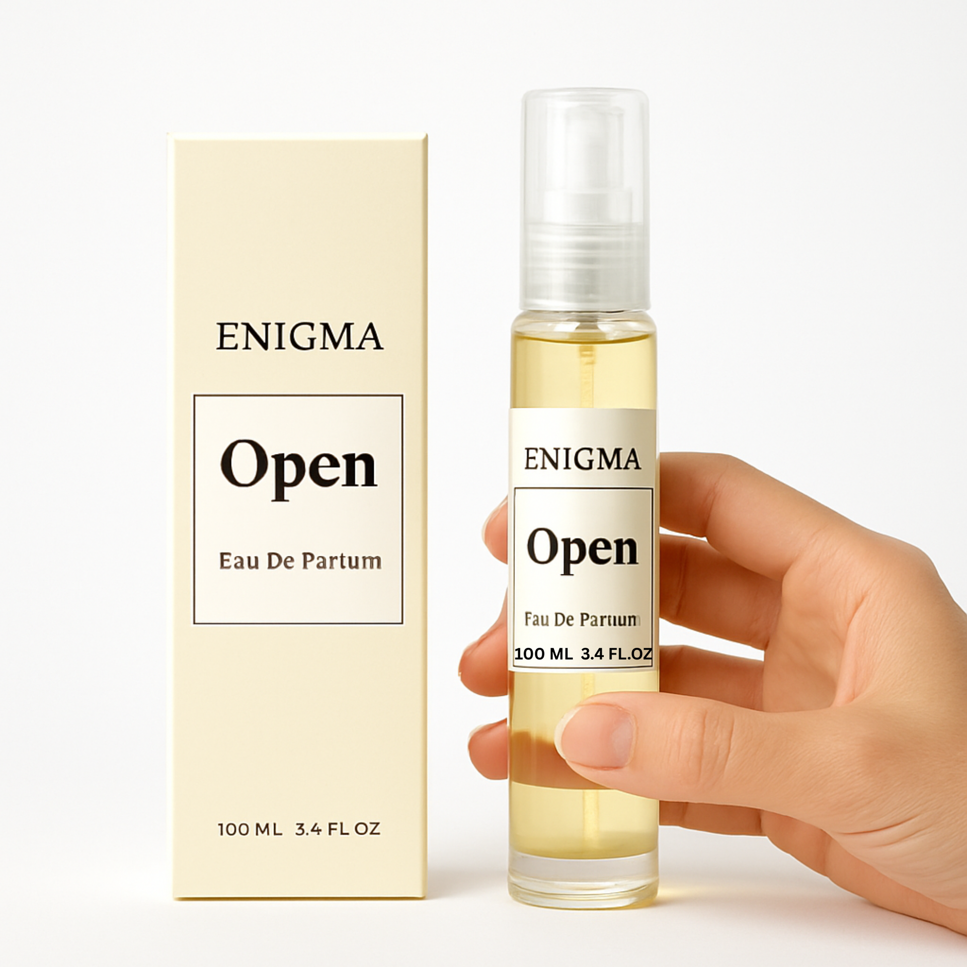 Enigma Open Eau De Parfum bottle and packaging held by a hand on a white background